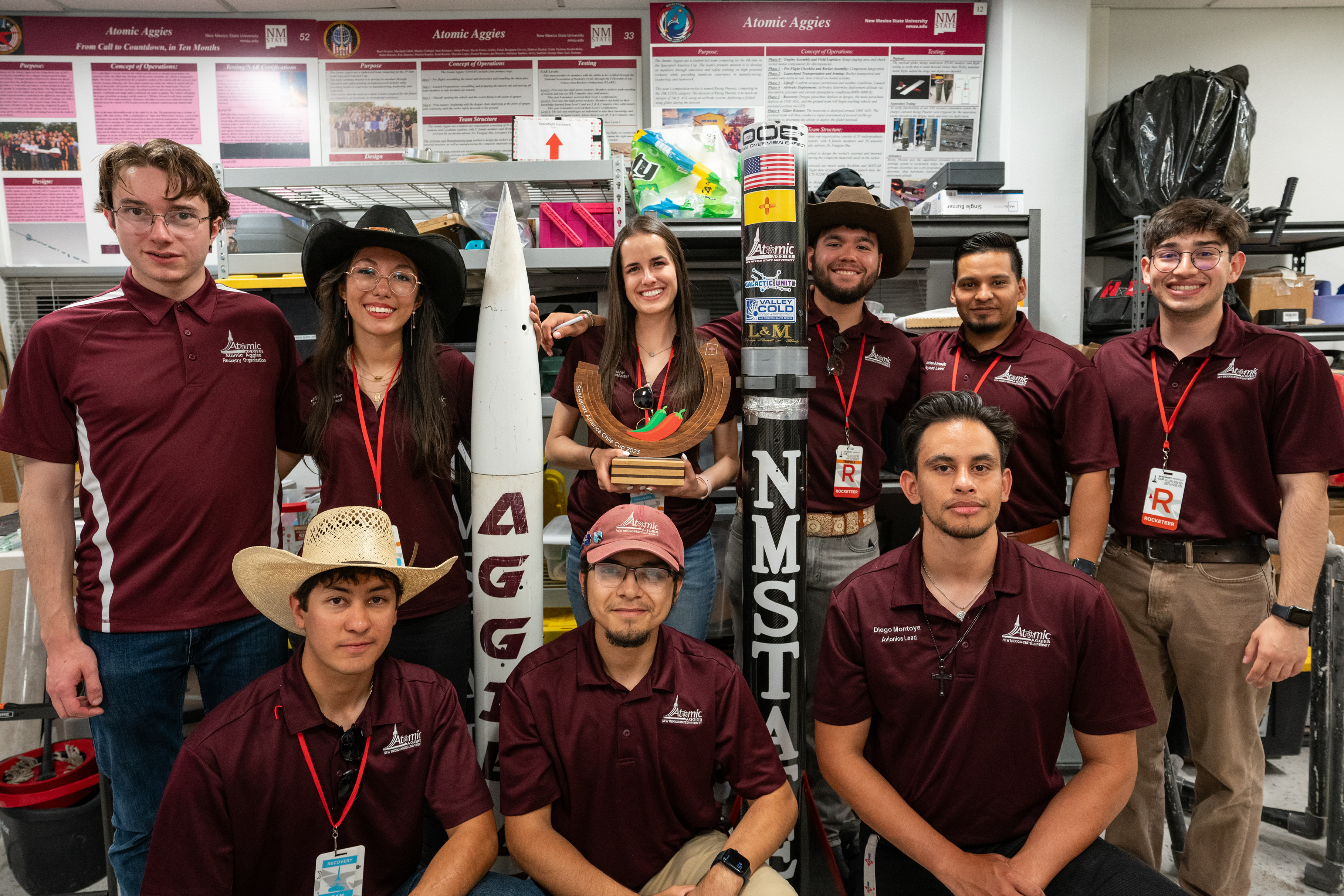 Atomic Aggies team photo standing next to competition rocket and chilie cup