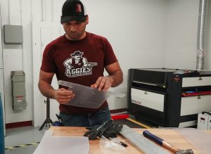 man holding face shield